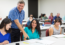 Accounting instructor working with students in the classroom