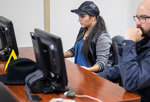 Computer Science students working with desktop devices in the lab