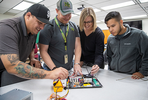 Information Technology students conducting a test in the lab