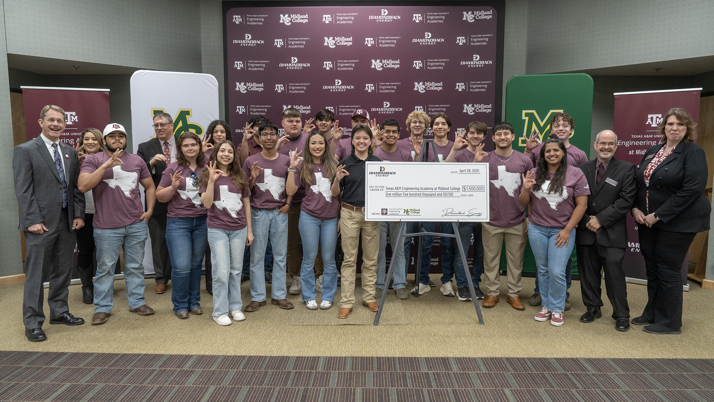 TAMU at MC students posing with Diamondback check