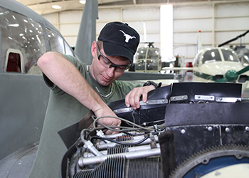 MC student working on an airplane engine