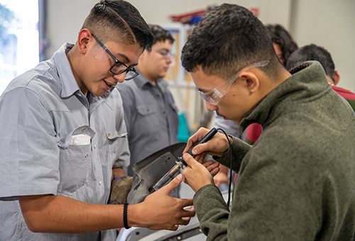 Automotive Technology students workin g on engine parts