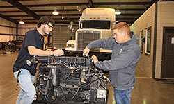 Student working on diesel engine in the shop