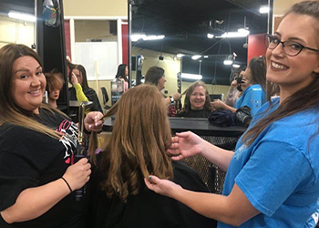 Cosmetology students cutting and styling at the MC salon