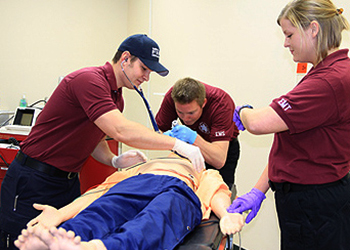 EMS Students in Lab Practice with SimLifeCenter Manikin