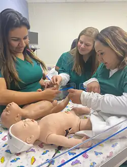 Nursing students attend to infants