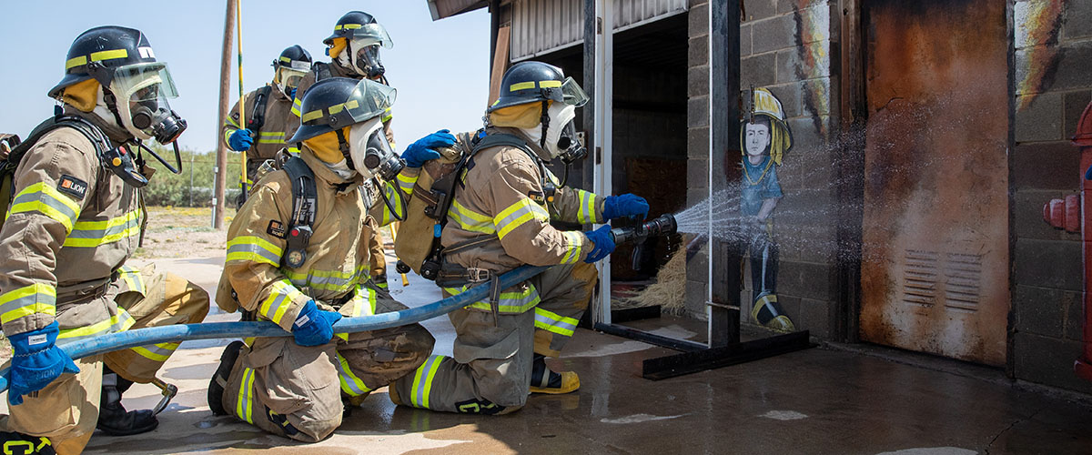 Fireman hosing building