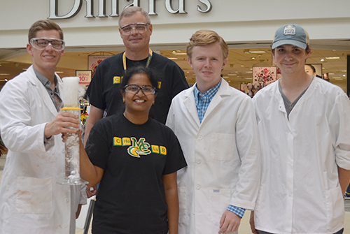 Chemistry instructors and students in outreach at shopping mall