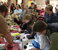 Geology student in community outreach at museum science night