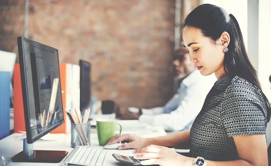 Lady working at her desk with a computer