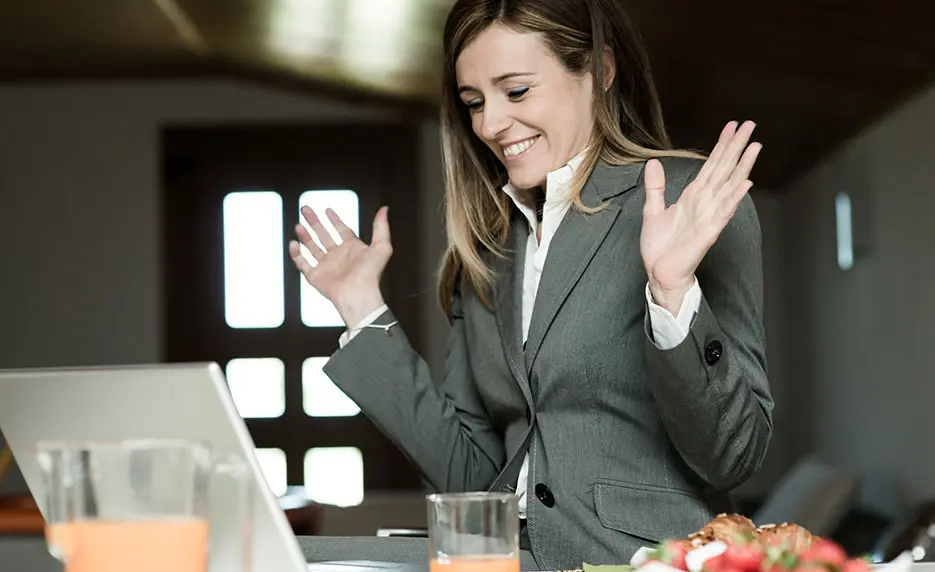 Business woman smiling while looking at her computer