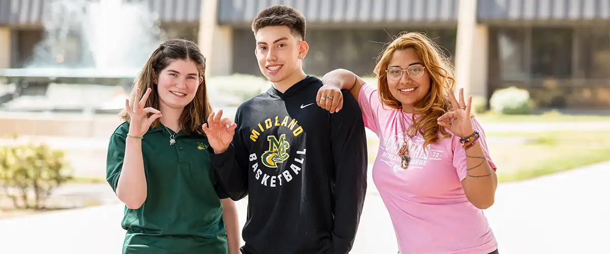 Three MC students in front of the fountain in Beal Plaza