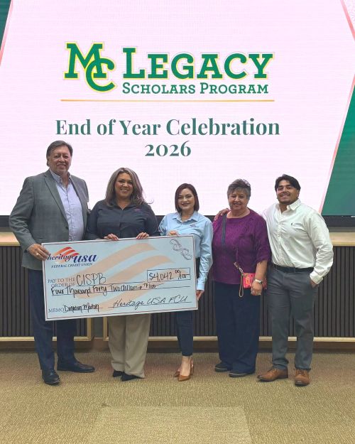 slegacy scholars pose with members from the Communities in Schools of the Permian Basin holding a big donation check