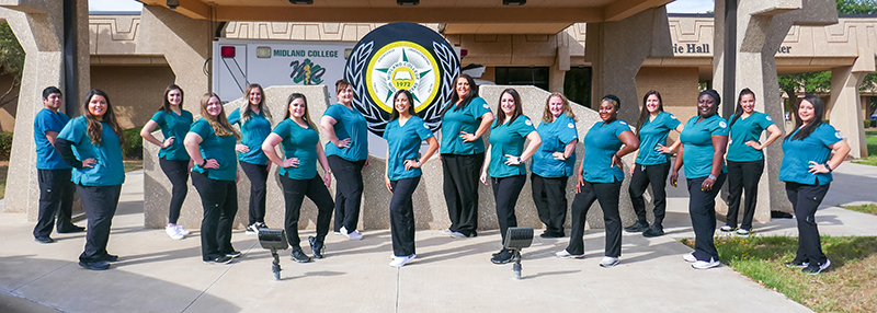 The image to use for this article. Listing image managed through RSS tab. May 2021 Associate Degree Nursing graduates standing in front of ambulance bay at F. Marie Hall SimLife center on the main Midland College campus.