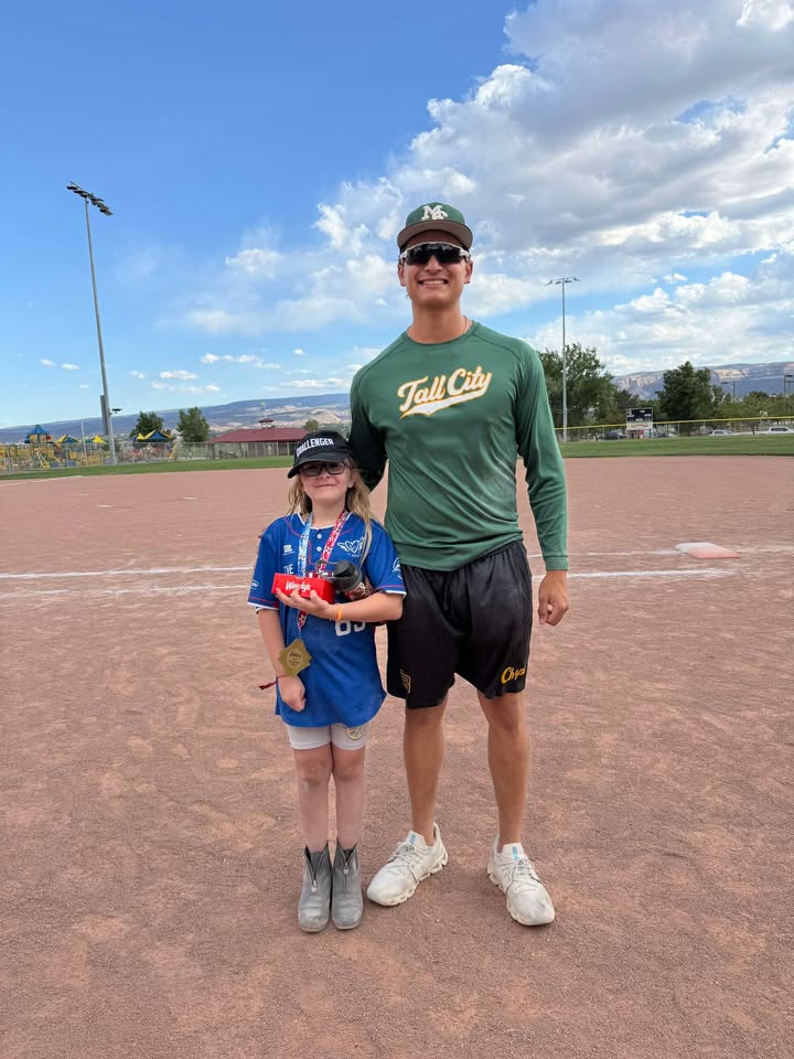 sMC Baseball Player AJ Velarde poses with his Challenger buddy Xoe at the JUCO World Series