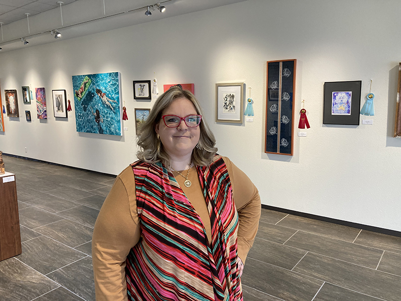 sLauren Disney standing in McCormick Gallery in the Allison Fine Arts Building on the main MC campus.