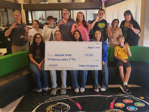 sMC students and staff gather in the eSports Arena holding a big check from Dingus Investments, Inc.