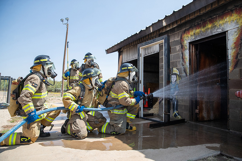 The image to use for this article. Listing image managed through RSS tab. Fire Technology students with water hose at Harris Field