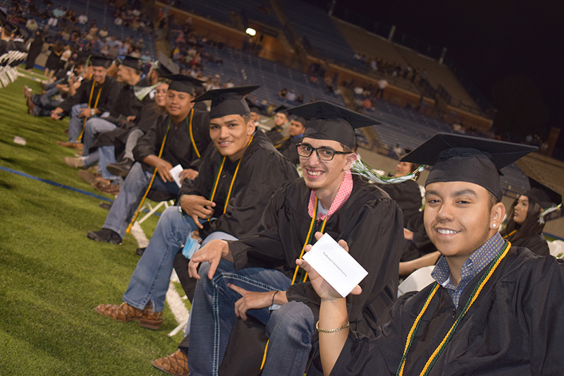 The image to use for this article. Listing image managed through RSS tab. males sitting on chairs during graduation ceremony