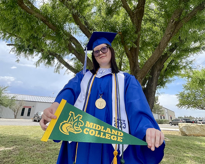 The image to use for this article. Listing image managed through RSS tab. Rylea Jackson standing outside WRTTC in Ft. Stockton in Ft. Stockton High School graduation regalia holding a Midland College banner.