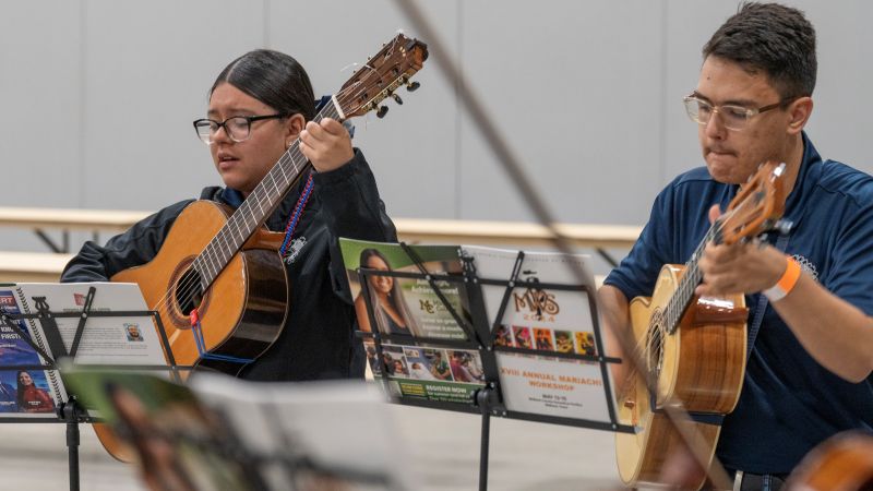 The image to use for this article. Listing image managed through RSS tab. students playing guitars sing in mariachi class 