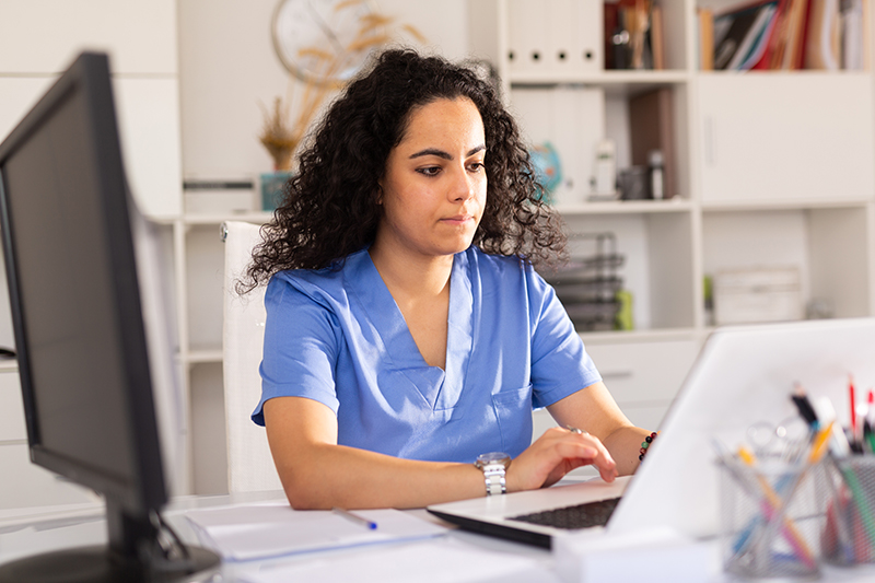 The image to use for this article. Listing image managed through RSS tab. Female at computer in medical office.