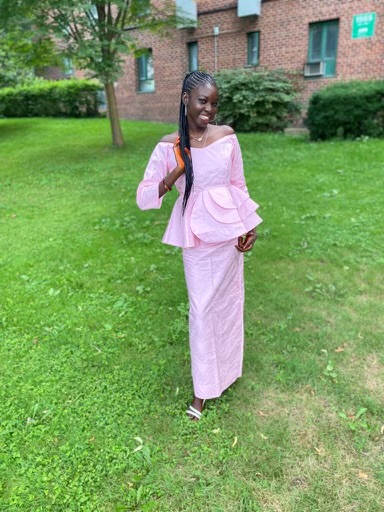sNdeye Ndour standing outside in native Senegal dress.