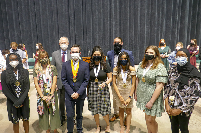 s2021 Phi Theta Kappa Officers (front row) and MC President Dr. Steve Thomas and MC Vice President of Instructional Services Dr. Damon Kennedy (back row)