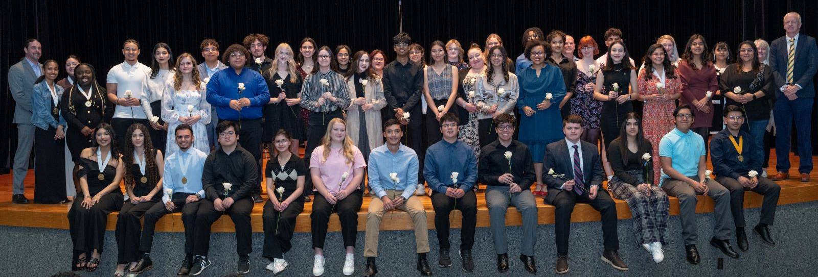 The image to use for this article. Listing image managed through RSS tab. Phi Theta Kappa inductees pose on stage at the Allison Fine Arts Building, Wagner & Brown Auditorium