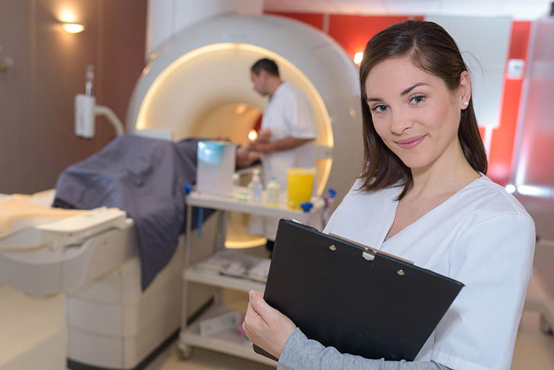 sFemale performing x-ray procedures.