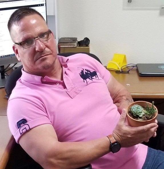 The image to use for this article. Listing image managed through RSS tab. Jason Reeves holding succulent plant.