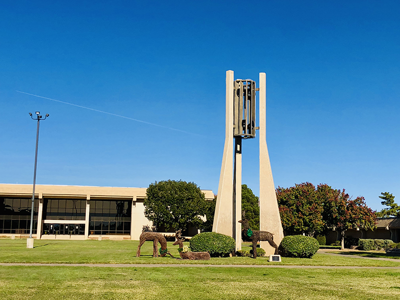 The image to use for this article. Listing image managed through RSS tab. Holiday decorated reindeer graze near Hodge Carillon Tower on MC main campus.