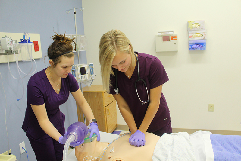 The image to use for this article. Listing image managed through RSS tab. Respiratory Care students practicing skills on manikin in F. Marie Hall SimLife Center.
