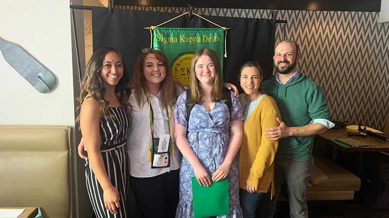 The image to use for this article. Listing image managed through RSS tab. From left to right MC English Honor students Shaquila Sarapao, Brycie Bowles and Harley Swiney with MC Sigma Kappa Delta advisors Stacy and Brendan Egan.