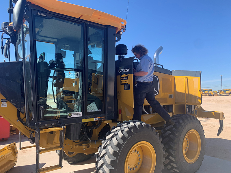 sWyatt Ahlstrand identifies 30 engine-related components on a John Deere 672GP motor grader.