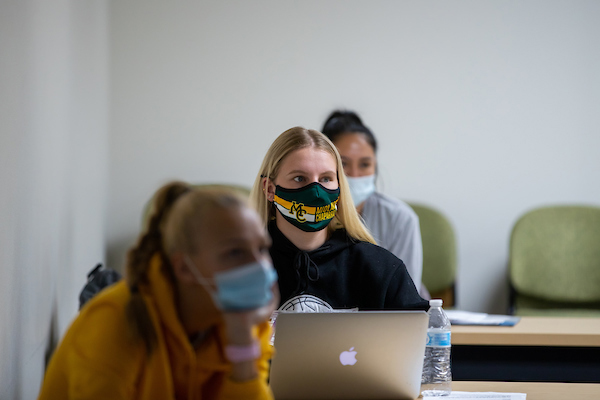 The image to use for this article. Listing image managed through RSS tab. Masked female student in class at computer