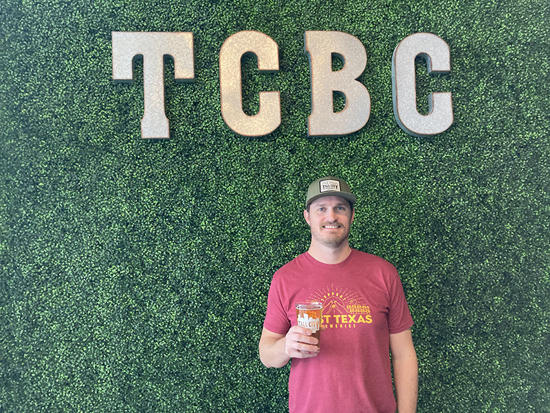 The image to use for this article. Listing image managed through RSS tab. Jeff Thomas standing in front of Tall City Brewing Company sign.